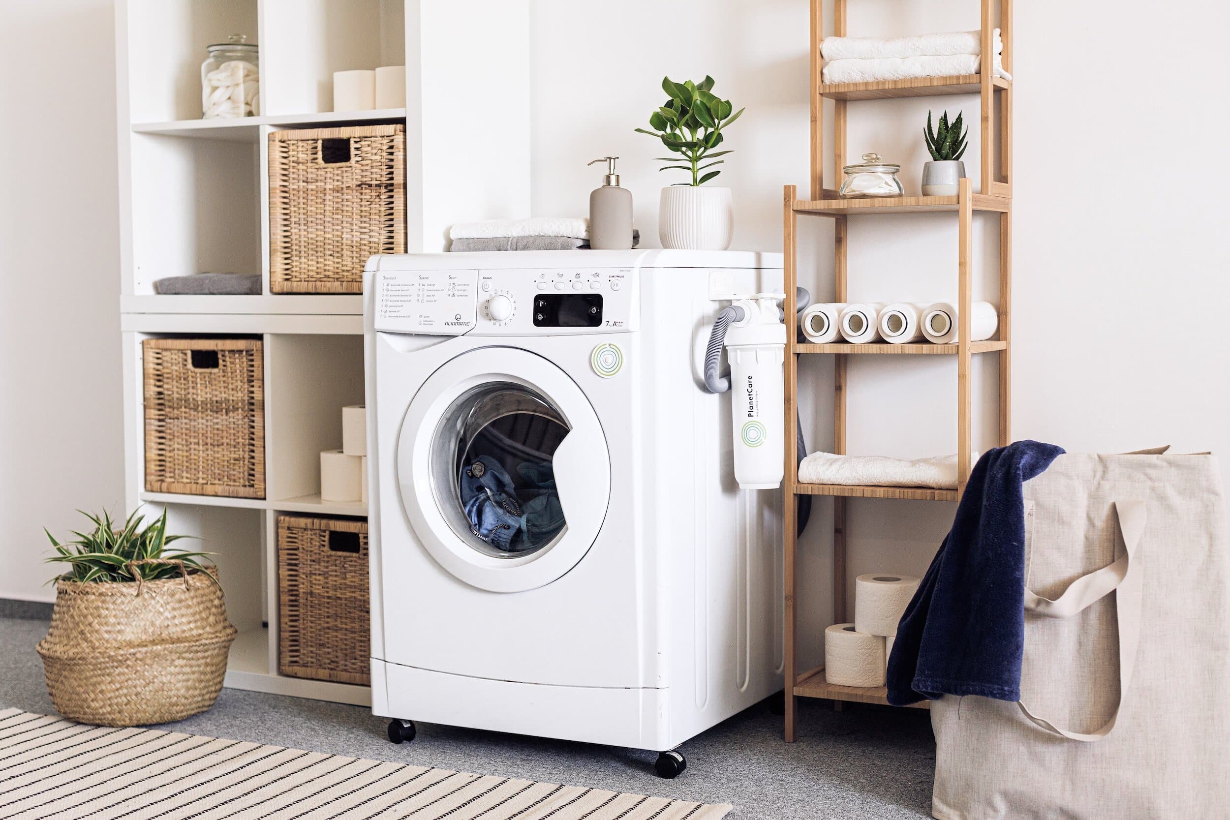 Functional laundry with integrated hamper and overhead cabinets