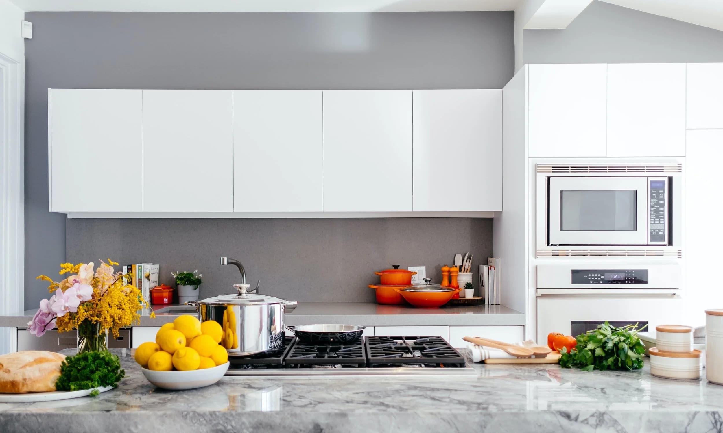 Light, bright Sydney family kitchen with stone island and integrated appliances